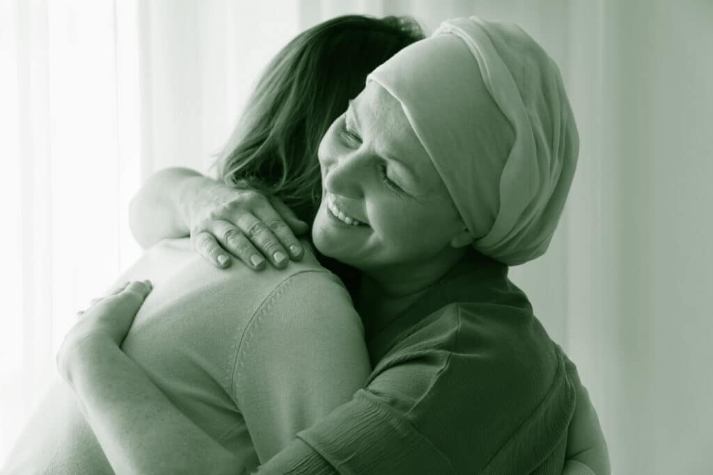 women hugging cancer green
