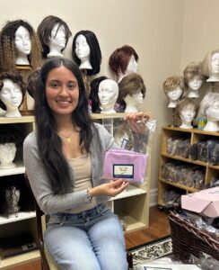 Sohum holding one of her silk pillowcases in the Wellspring Chinguacousy wig room